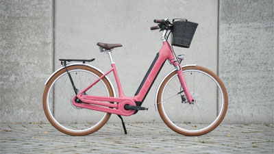On peut voir un vélo électrique rose Cube Ella Hybrid.